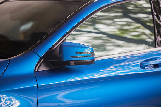 Rear-view Mirror Folds Off For Safety At Car Park,  Rear-view Mirror Of Blue Car, Black Tinted Glass