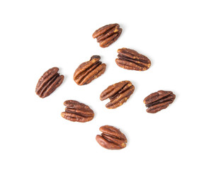 Pecan nuts topped with light salt isolated  on white background . top view