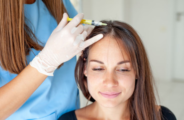Naklejka premium cosmetic injection in the clinic in the hair