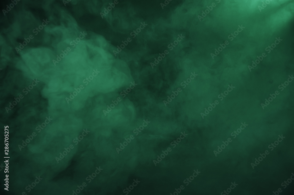 Wall mural green smoke on the dark background