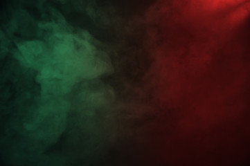 Obraz na płótnie Canvas Red and green smoke on the dark background