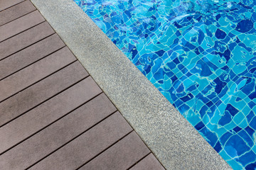 Empty wooden deck with swimming pool.
