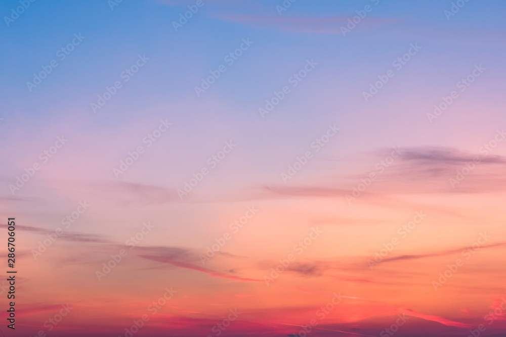 Wall mural sunset background. sky with soft and blur pastel colored clouds. sunshine through the gradient cloud