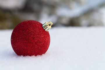 Bright balls on a clean pure snow for natural winter background. New year composition. Shallow...