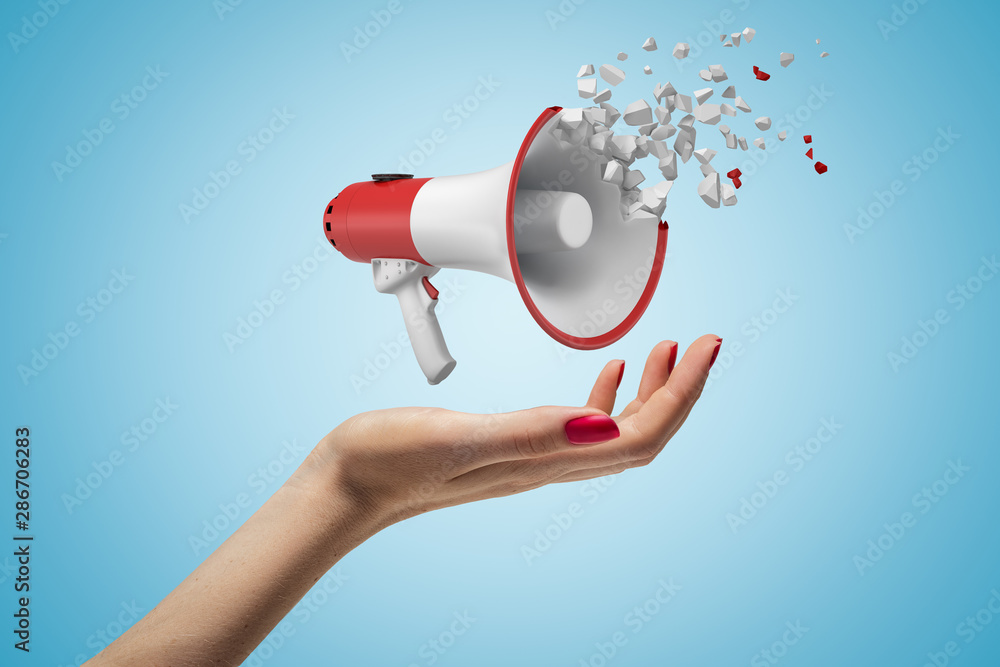 Aufkleber close-up of woman's hand facing up and levitating megaphone that has started to disintegrate into pi
