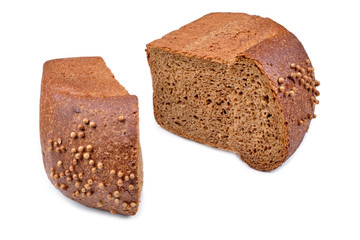 loaf of dark bread partly cut in slices, isolated on white