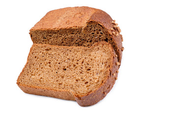 loaf of dark bread partly cut in slices, isolated on white