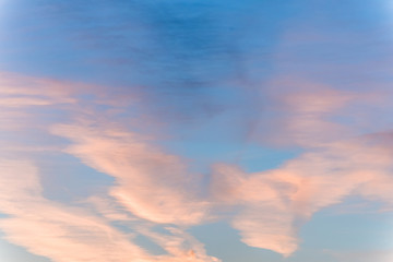 sunset background. sky with soft and blur pastel colored clouds. sunshine through the gradient cloud on the beach resort. nature. sunrise.  peaceful morning