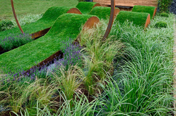 Undulating lawns in a garden replicating sound waves with mixed grasses and lavender