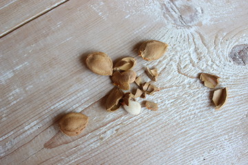 Chopped apricot pits on the background of boards.