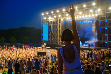 Woman is dancing at open air music festival
