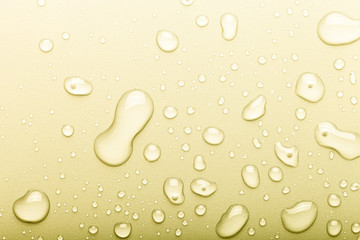 Drops of water on a color background. Selective focus. Yellow. Toned