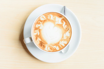 Top view of hot coffee on table / hot cappuccino with nice pattern milk foam 