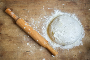 dough raw, flour, rolling pin for rolling (preparation for cooking) menu concept. food background....