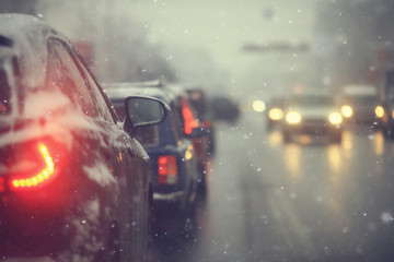 cars on winter road traffic jam city / winter weather on the city highway, the view from car in the...