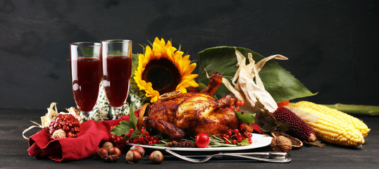 Baked turkey or chicken. The thanksgiving table is served with a turkey, decorated with fruits, salad and nuts. Fried chicken, table. Thanksgiving