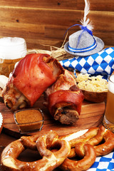 Traditional German cuisine, Schweinshaxe roasted ham hock. Beer, pretzels and various Bavarian specialties. Oktoberfest background