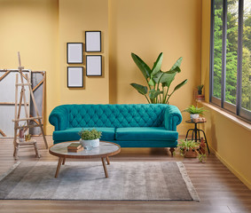 Modern yellow living room, blue classic sofa, easel and painting style, frame vase of plant and interior decoration.