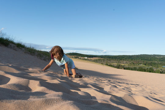 Tired Girl Climbing Sand Dune