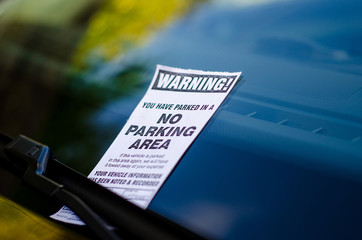 Close-up of parking ticket on car's windshield