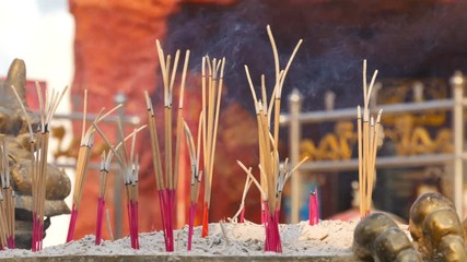 Video 4k of close-up Incense sticks burning with smoke