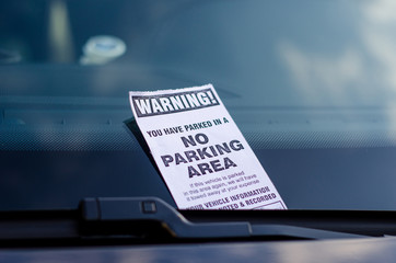 Close-up of parking ticket on car's windshield