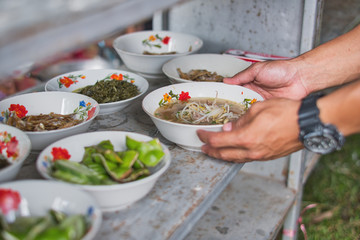 Close up of hand giving, taking, preparing food to hands of a beggar. Food donation concept.