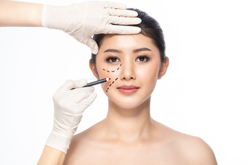 Lines on face, close up, plastic surgery concept, doctor's hand in glove making marks on patient's face..Asian beauty  Woman in beauty salon. plastic surgery clinic.