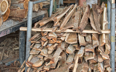 Stack of lumber woods in the steel container at wood factory or sawmill.