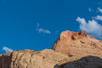 Capitol Reef National Park low angle landscape of massive stone mountain top against the sky