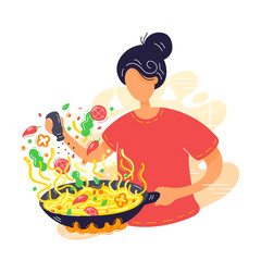 Young woman coocking noodles in wok frying pan