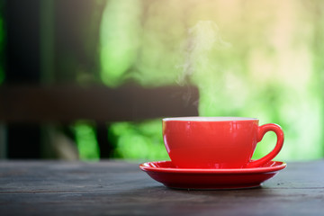 The warm coffee has hot steam coming out of the glass