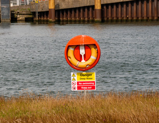 Lifebuoy on a stand with water in the background