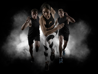Sporty young woman and men running - obrazy, fototapety, plakaty