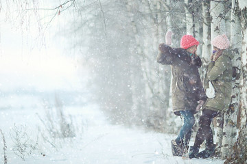 Group of a stylish young girlfriends walking outdoors in winter