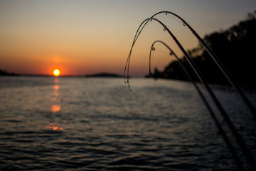 Fototapeta na wymiar .sunset from the sea side of the bay with fishing rods