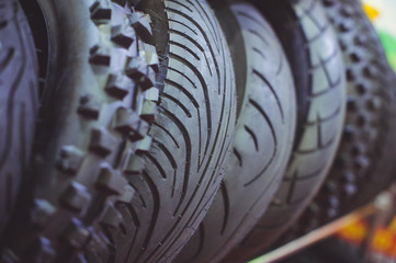 motorcycle tires in a assortment of a store are arranged in a row close-up. sale