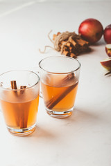 Autumn hot spicy tea glasses with cinnamon sticks