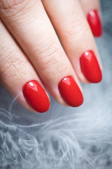 Female hand with a beautiful close-up red manicure 
