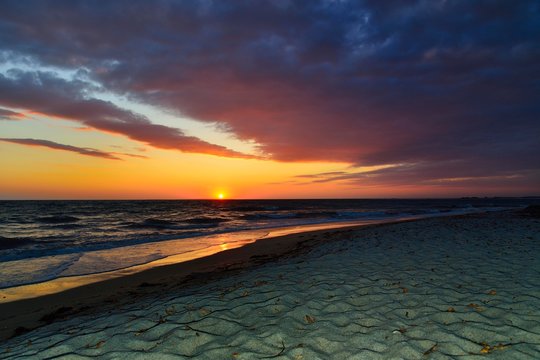 Sunset at sea with cloudy sky, Mari Ermi, Sinis Peninsula, Province of Oristano, Sardinia, Italy, Europe