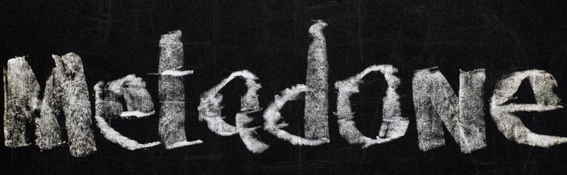 panoramic shot of black chalk board with lettering metadone