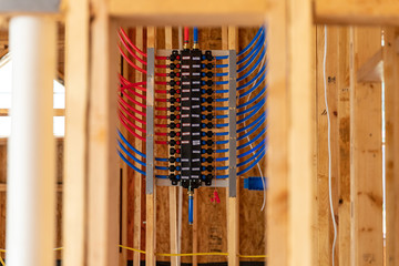 PEX plumbing manifold for water distribution in new home construction. selective focus