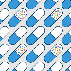 Medical background of pills of simple shape of blue and white color and with granules inside.