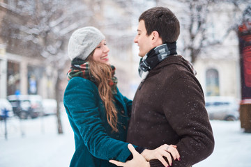 Focus on hands. Happy couple playful together during winter holidays vacation outside in snow park