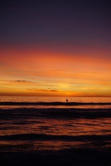 VIBRANT SUNSET WITH SURFERS SPORTS