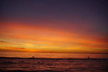 VIBRANT SUNSET WITH SURFERS SPORTS