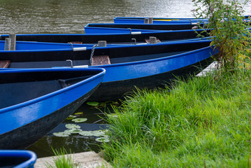 Beautiful, blue boats in the canal near  Zoetwourde farm, Netherlands