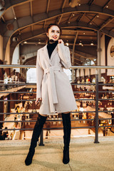 Fashion and trendy clothes. girl in a light woolen coat. Autumn style. Interior photo. spring autumn collection. women's clothing business style office wear casual. Young sexy woman