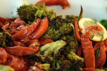 On the dish are red pepper, cauliflower, lemon slices. The concept is a vegetable diet.