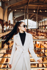 Fashion and trendy clothes. girl in a light woolen coat. Autumn style. Interior photo. spring autumn collection. women's clothing business style office wear casual. Young sexy woman